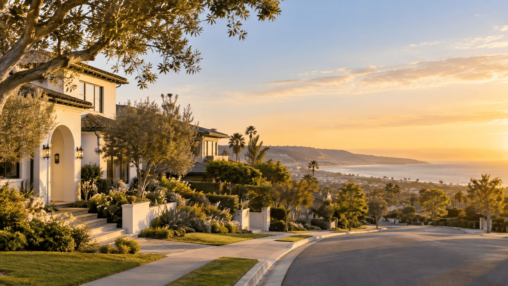 A Southern California coastal neighborhood at golden hour with homes, palm trees, and an ocean view.